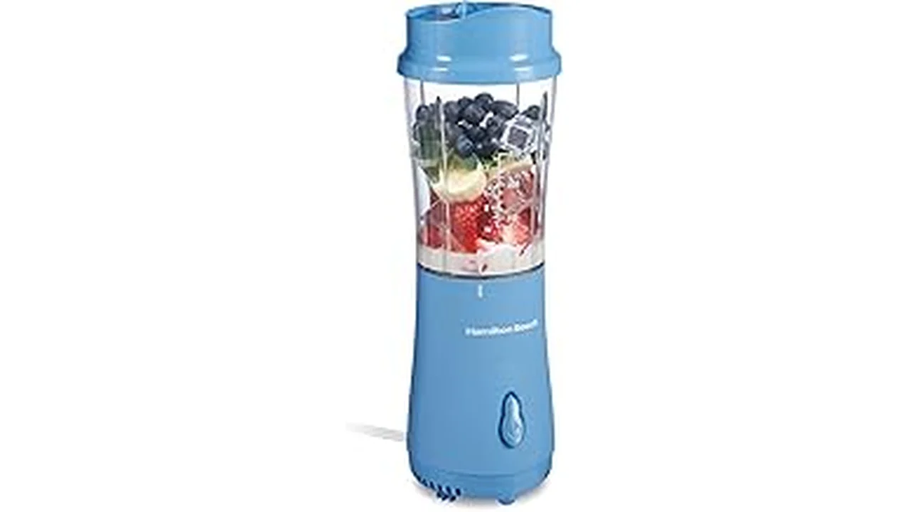 The image shows a sleek portable smoothie maker with a smoothie ready to enjoy.